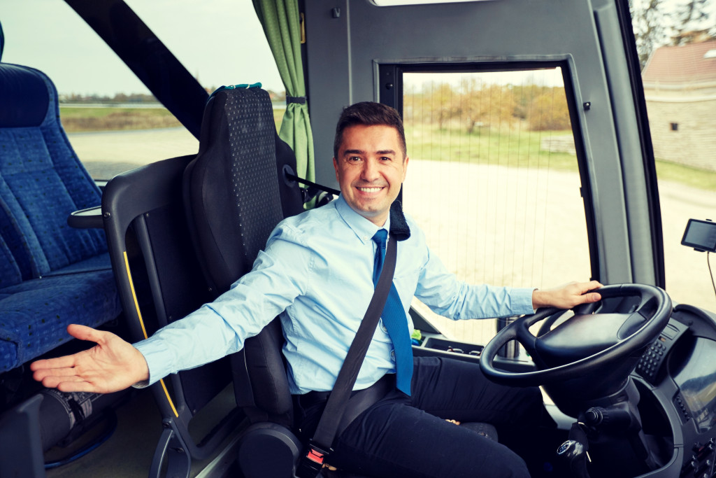 A bus driver inviting customers
