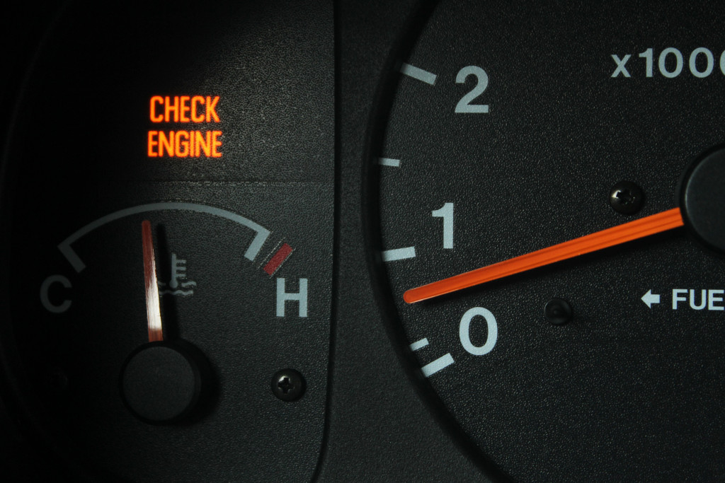 A car speedometer showing waring light of check engine 