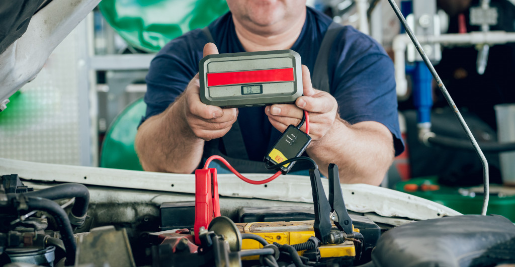 A man trying to Jump start a battery