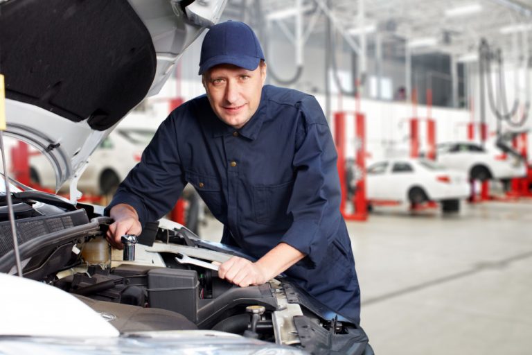 A car mechanic is repairing a car