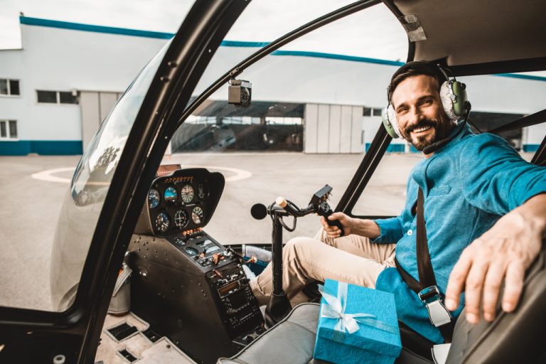 smiling pilot of a small helicopter