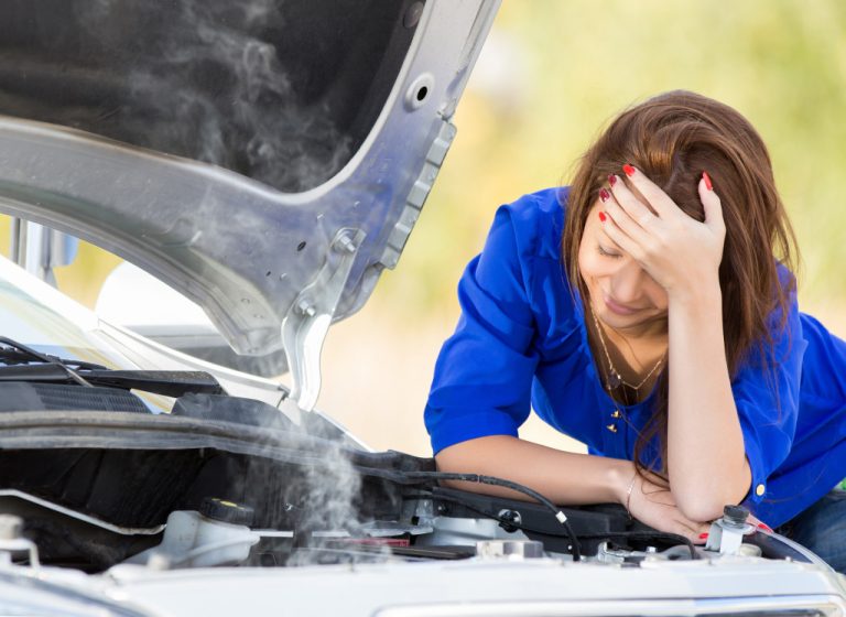 a worried woman with broken car
