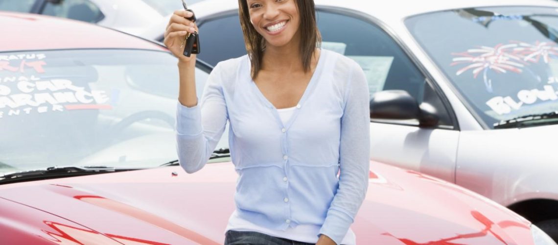 woman holding car key